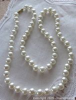 Full view of 22-inch pearl strand showing clasp and uniform pearls