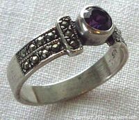 Side view of sterling silver ring showing bezel-set amethyst and marcasite shoulders