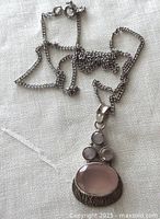 Chain and pendant laid out showing overall appearance