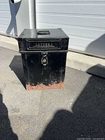 Front view showing LETTERS slot, padlock hasp and rusted base