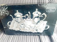 Box front showing image of full silver-plated tea and coffee set
