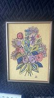 Front view of framed embroidered floral artwork