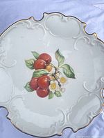 Top view showing cherries design and scalloped gilt rim