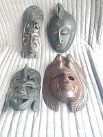 All four wooden masks laid out together