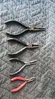 All four pliers laid out showing sizes and handle colors