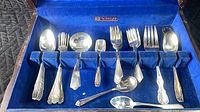 Open chest showing flatware pieces in blue velvet interior