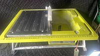 Top view of Ryobi WS722 wet tile saw showing table, fence, blade guard and stand