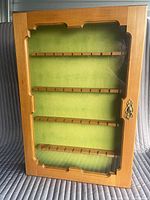 Front view of wood display cabinet with glass door