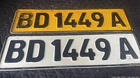 Front view of yellow and white plates showing full registration