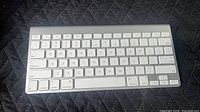 Top view of the Apple wireless keyboard showing key layout and surface wear