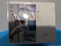 Stack of football trading cards with SkyBox Dallas Cowboys card on top