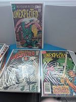 Three The Unexpected comics including Alligator Alley, astronaut, hockey goalie covers