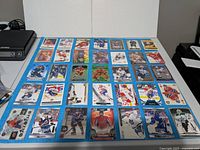 Overhead view of all 35 hockey cards arranged in a grid on table