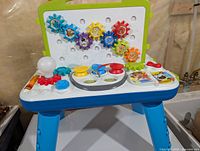 Front view showing gears, buttons, light bulb and overall table structure