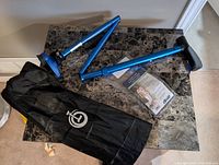 Collapsible cane components, base, bag, booklet on tabletop