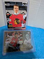 Fronts of both Connor Bedard cards in holders