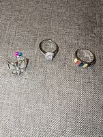 Three rings laid out on fabric surface