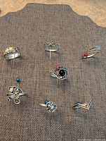 All seven rings arranged on fabric backdrop