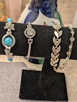 All four bracelets displayed on bracelet stand