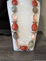 Front view of gemstone necklace on display bust