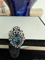 Front view of ring showing blue glass stone and filigree setting
