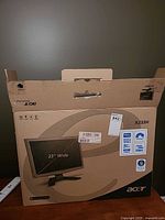 Front of Acer retail box showing model X233H, 23" Wide specification