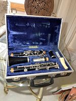 Open case showing all clarinet pieces in blue velvet interior