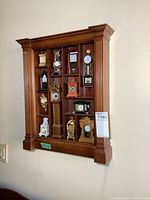 Full view of wooden rack with all miniature clocks