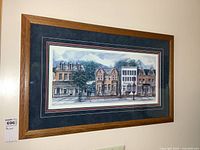 Framed signed and numbered print on wall