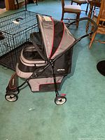 Side view of Gen7Pets grey and black pet stroller showing canopy, wheels and frame