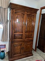 Front view of armoire with four doors and crown molding