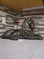 Full view of recumbent stone lion statue on countertop