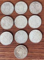 All ten coins front side visible on wood surface