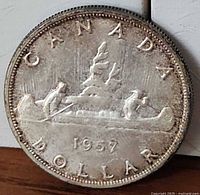 Reverse showing CANADA DOLLAR 1957 with Voyageur canoe design