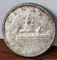 Reverse side showing Voyageur canoe design and date 1959