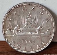 Reverse of 1961 Canadian silver dollar with voyageur canoe design