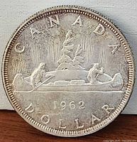 Reverse showing voyageur canoe design and 1962 date