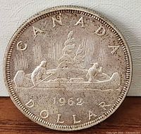 Reverse side showing CANADA DOLLAR 1962 canoe design