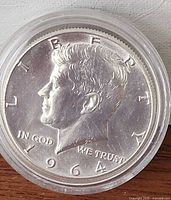 Obverse view of 1964 Kennedy silver half dollar in capsule