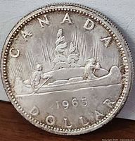 Reverse: Voyageur canoe design with 1965 date visible