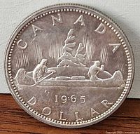 Reverse showing CANADA DOLLAR, Voyageur canoe design and date 1965