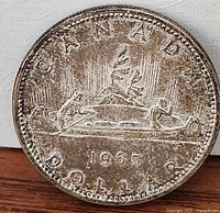 Reverse side showing Voyageur canoe design, date 1965, denomination Dollar