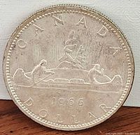 Reverse side showing canoe voyageur design and 1966 date