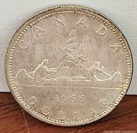 Reverse of 1966 Canadian silver dollar showing Voyageur canoe design and date