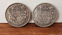 Both coins reverse showing Canadian coat of arms, dates 1944 and 1953 visible