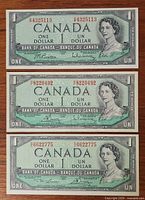 All three 1954 $1 banknotes laid out horizontally, full view of obverse