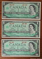 Three Centennial $1 notes laid out horizontally