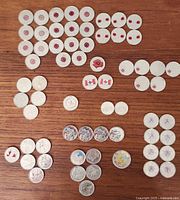 Overall view of all 62 coins laid out on wood surface