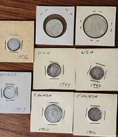Group shot of eight silver coins in holders