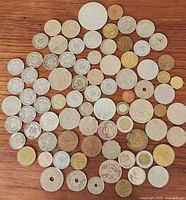 Group shot of all coins laid out on wood surface